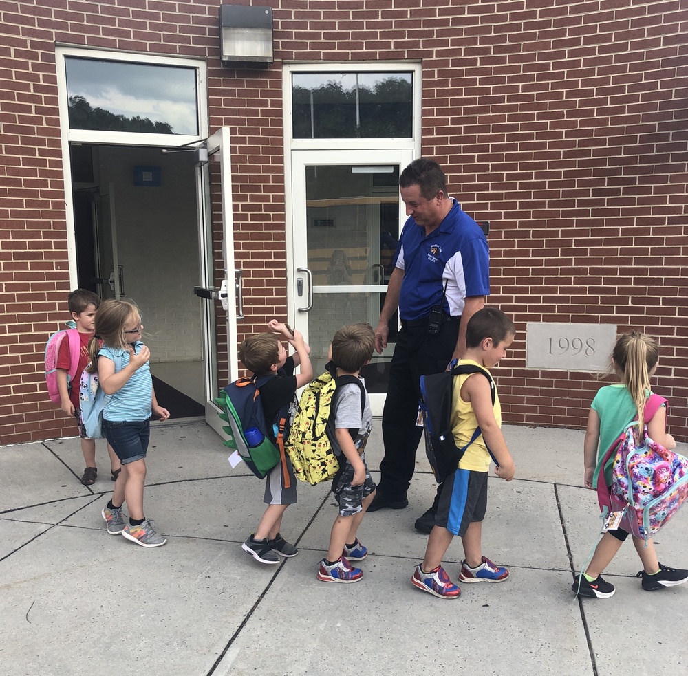 Officer Kovel greets Bedford Elementary students during dismissal.