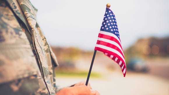 Veteran holding the American Flag